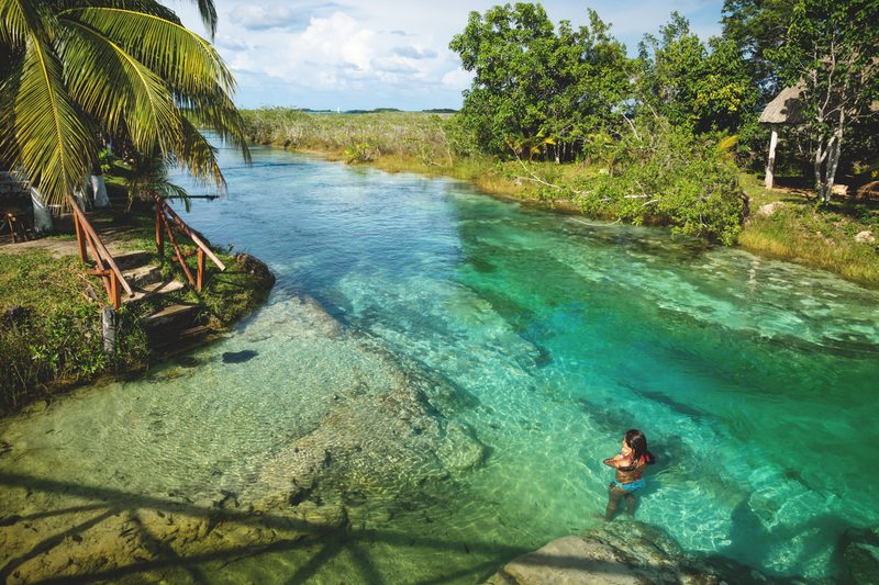 Woman swimming in lagoon.