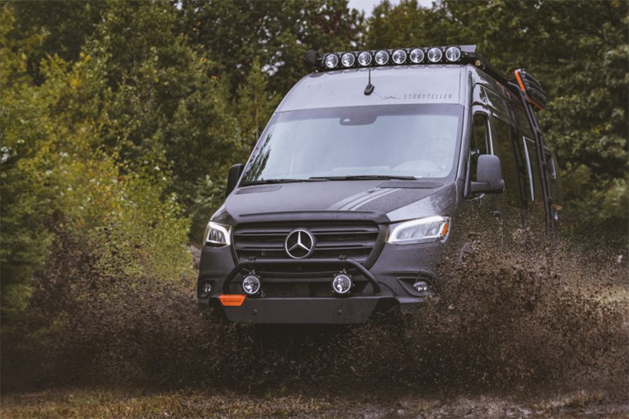 Storyteller Overland Beast Mode camper van driving through mud.