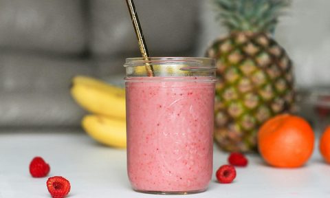 a raseberry smoothie in a mason jar on a table