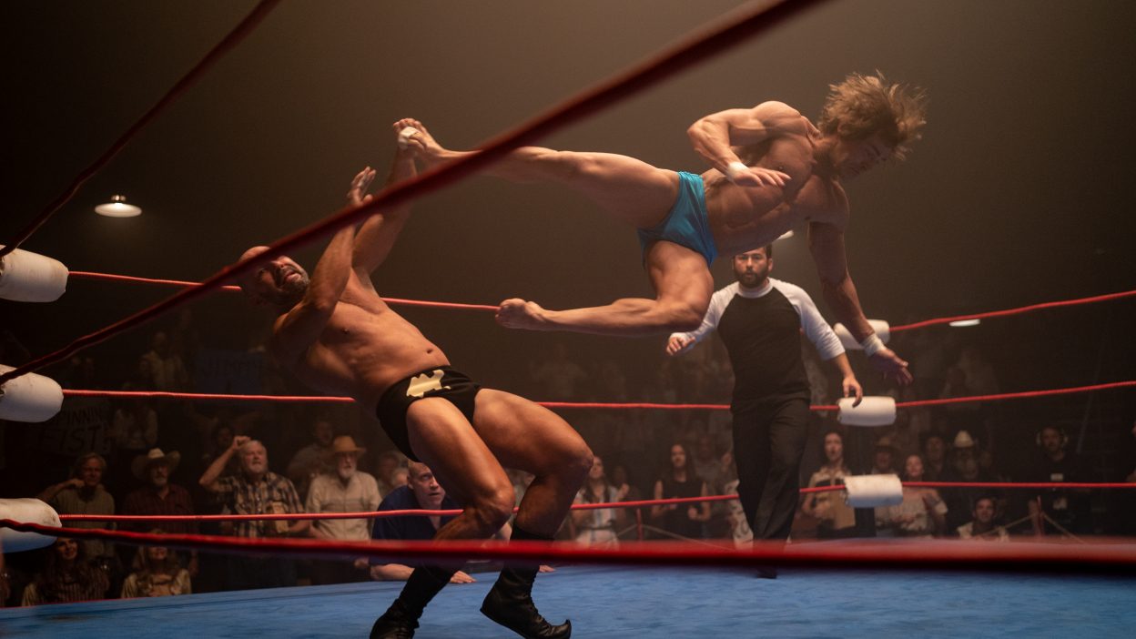 Zac Efron flying through the air in the wrestling ring in The Iron Claw.