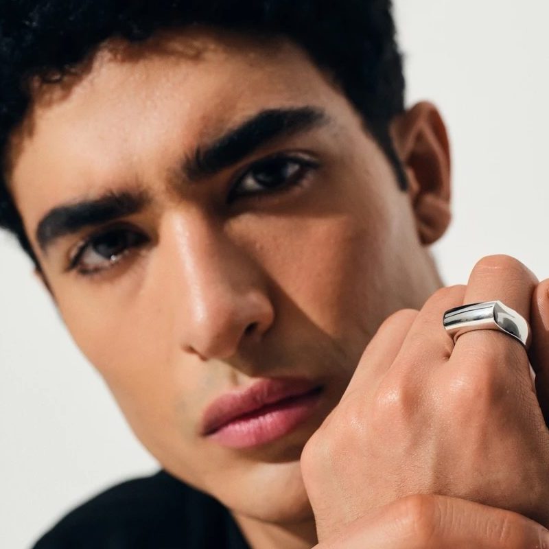 man wearing Tom wood crest ring