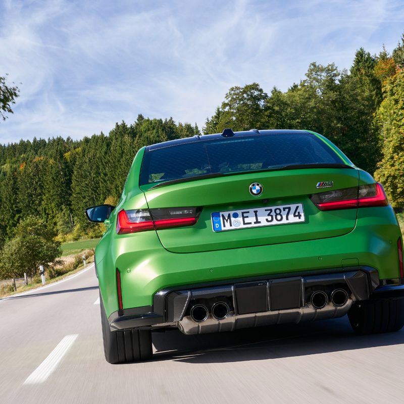 2025 BMW M3 Competition (European model) rear view on a country road.