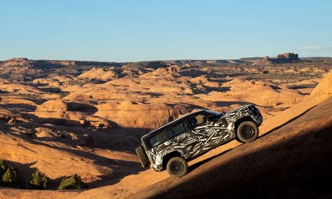 2025 Defender OCTA limited high-performance edition climbing a steep desert incline