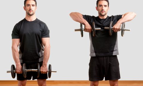 Adobe image man wearing black shorts doing upright row exercise with dumbbell in gym on wooden floor white background