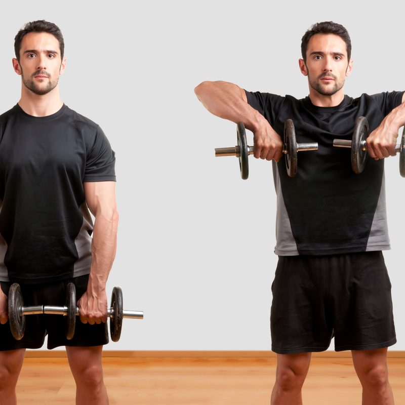 Adobe image man wearing black shorts doing upright row exercise with dumbbell in gym on wooden floor white background