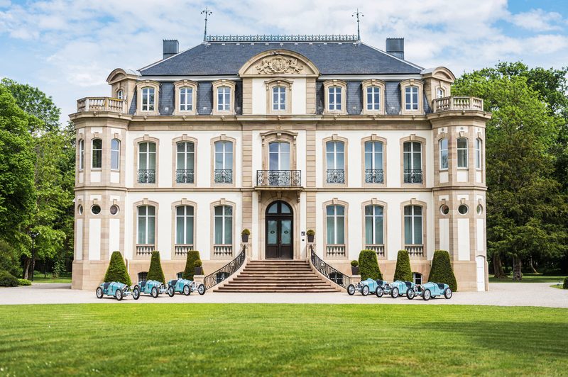 Château Saint Jean in Molsheim with six Bugatti Baby II Type 35 Centenary Editions parked in front.