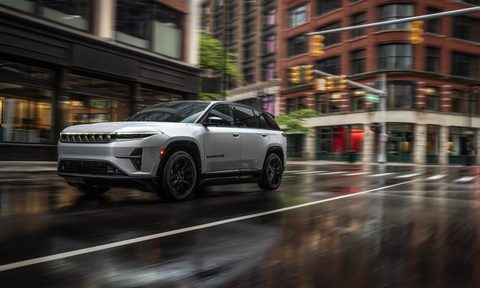 Jeep Wagoneer S Launch Edition driving on a rainy wet city street.