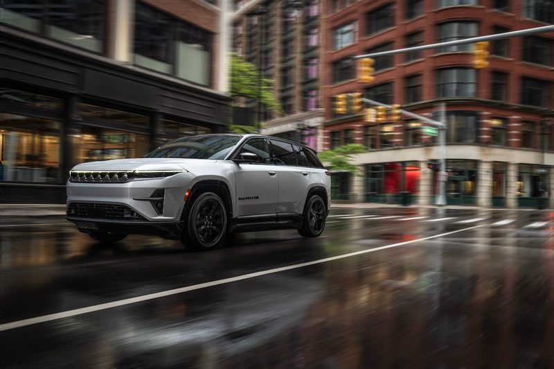 Jeep Wagoneer S Launch Edition driving on a rainy wet city street.