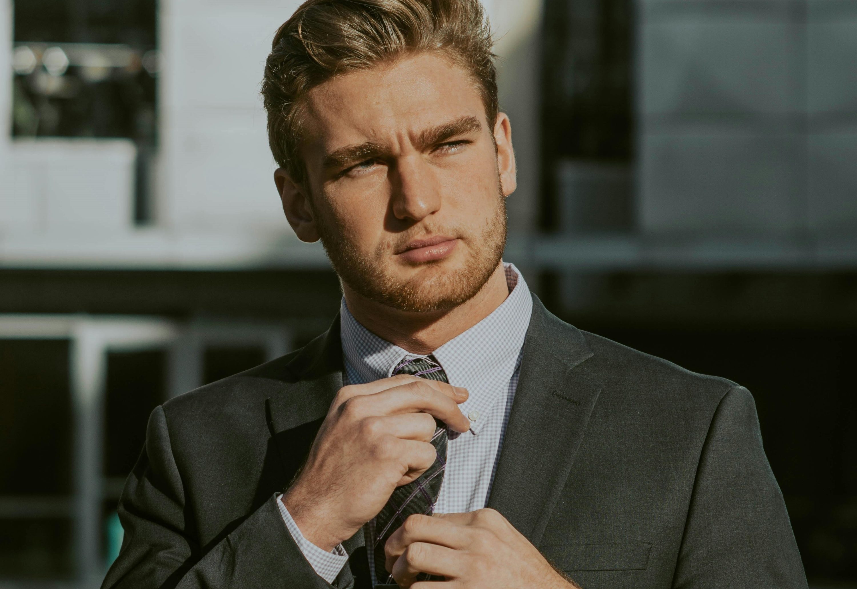 Man adjusting his tie