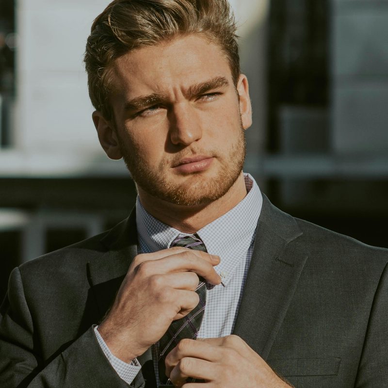 Man adjusting his tie
