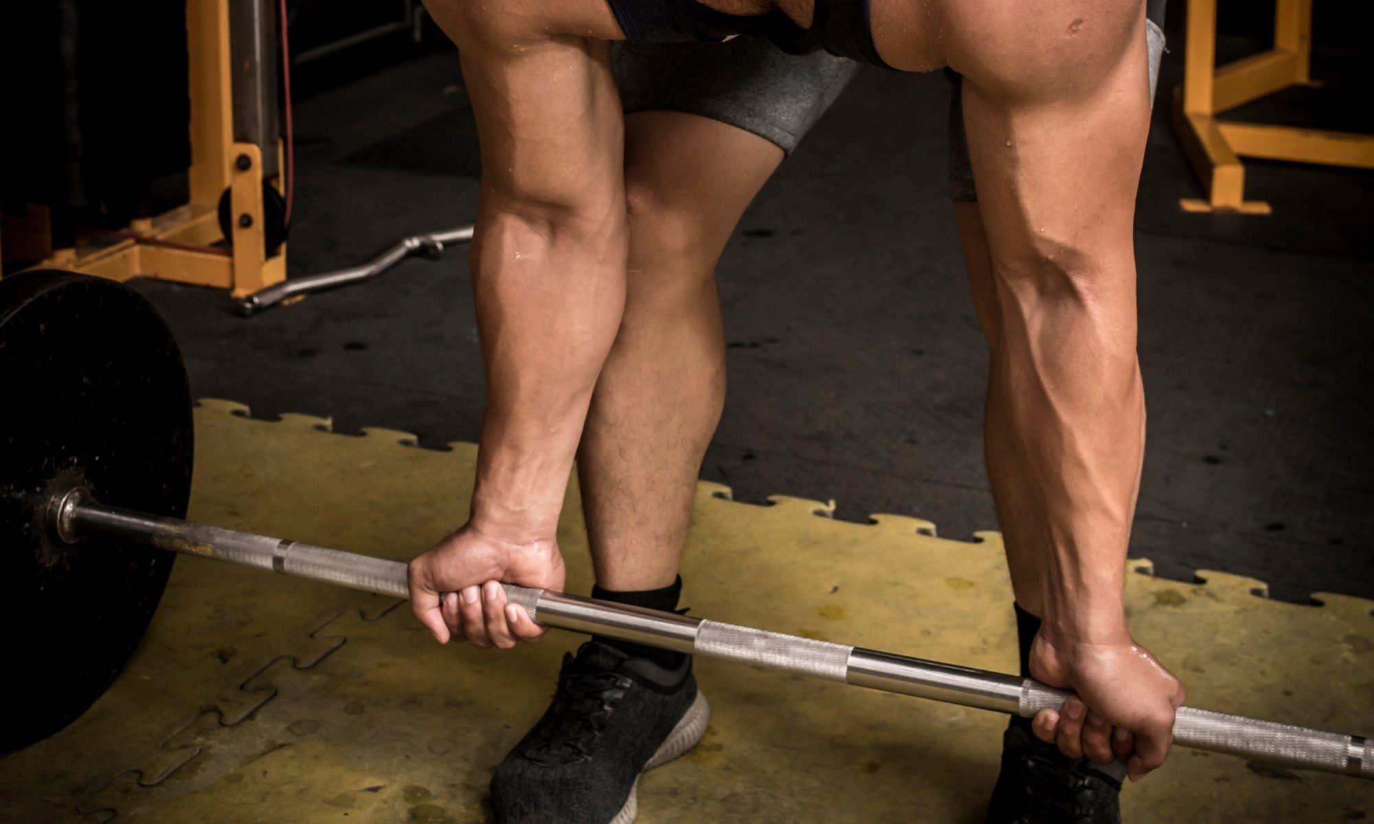 Man doing reverse-grip barbell row exercise