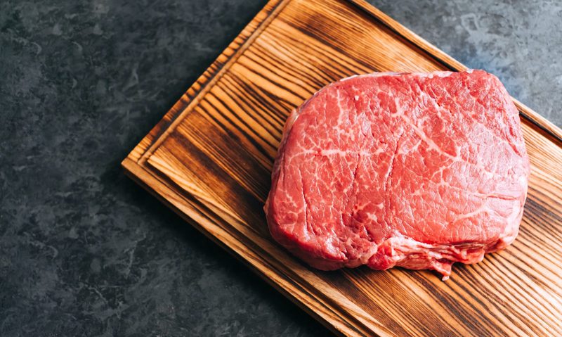 Raw steak on cutting board