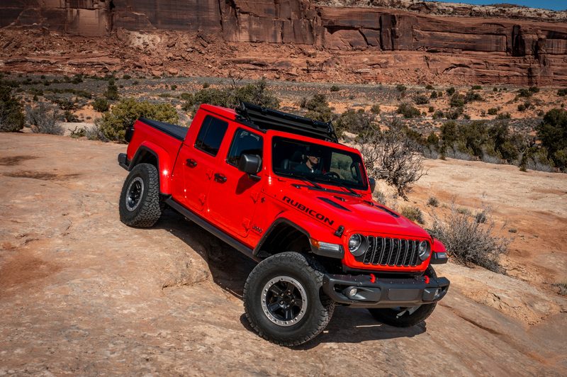 Red 2024 Jeep Gladiator Rubicon descending rocky rise in Utah