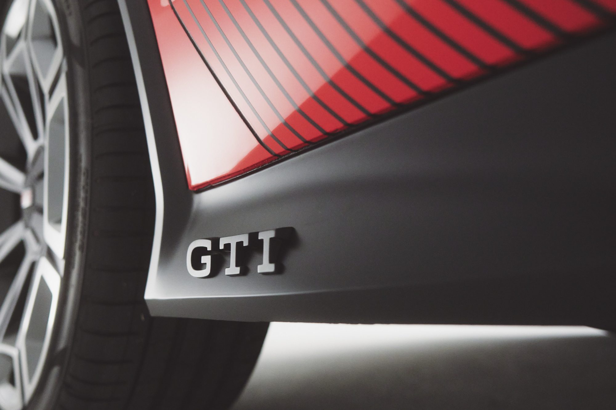 Volkswagen GTI EV concept in red left lower driver door panel with GTI logo.