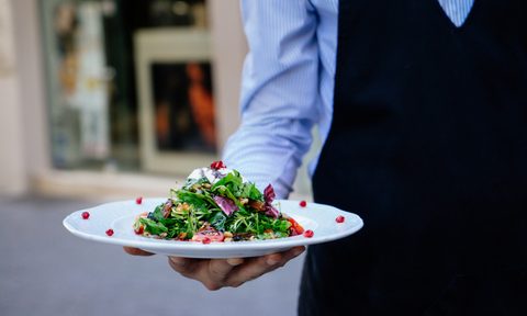 Server with dish in Greece