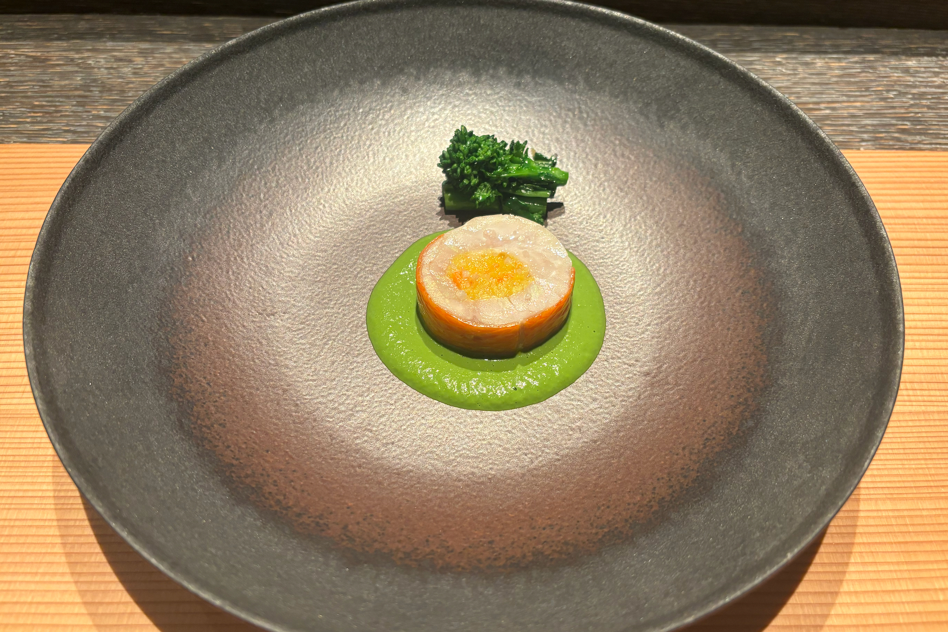 round fish course on large gray plate