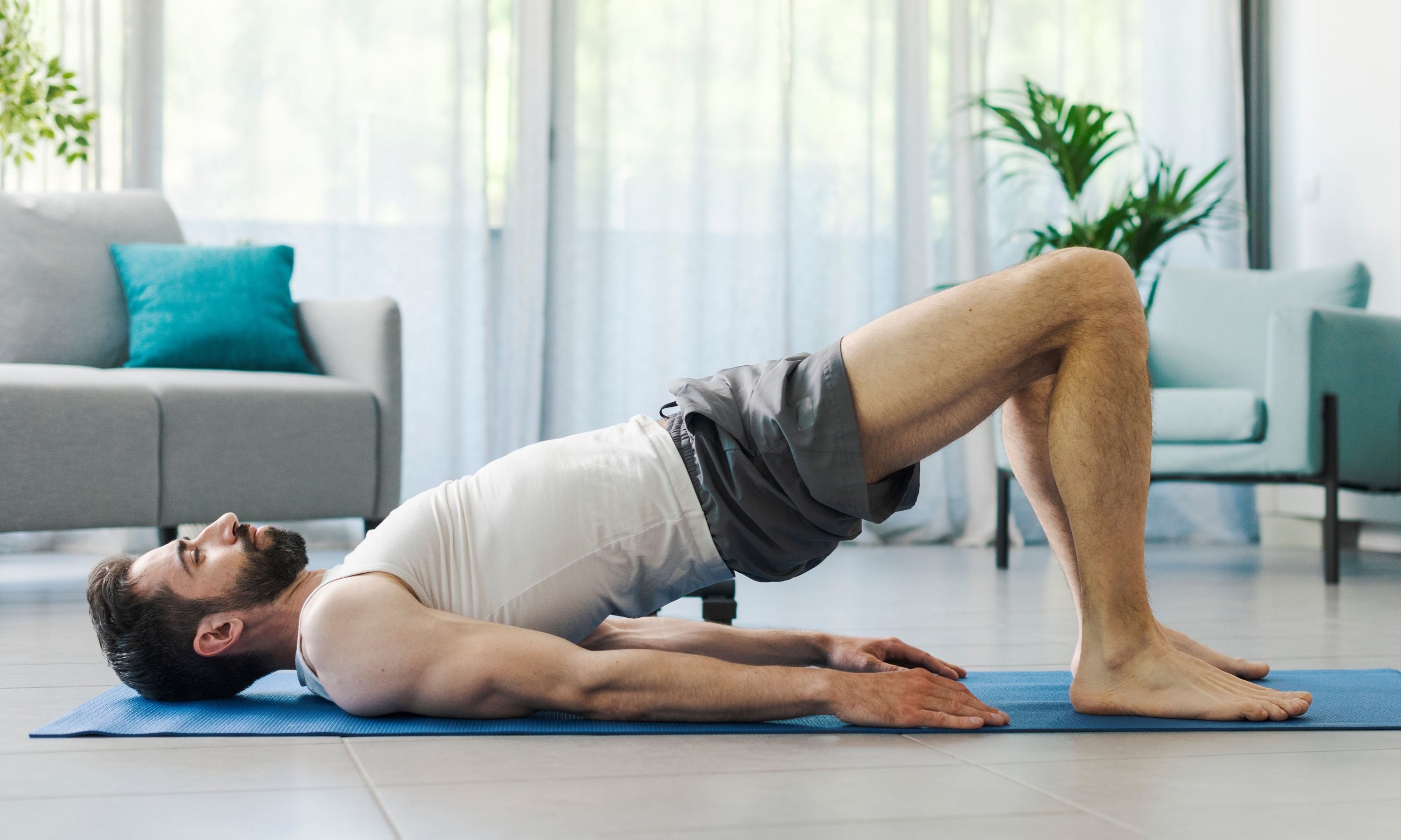 Man doing a glute bridge at home