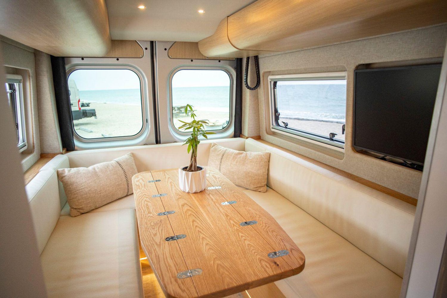 Convertible dinette sofa inside the Noovo Plus camper van.