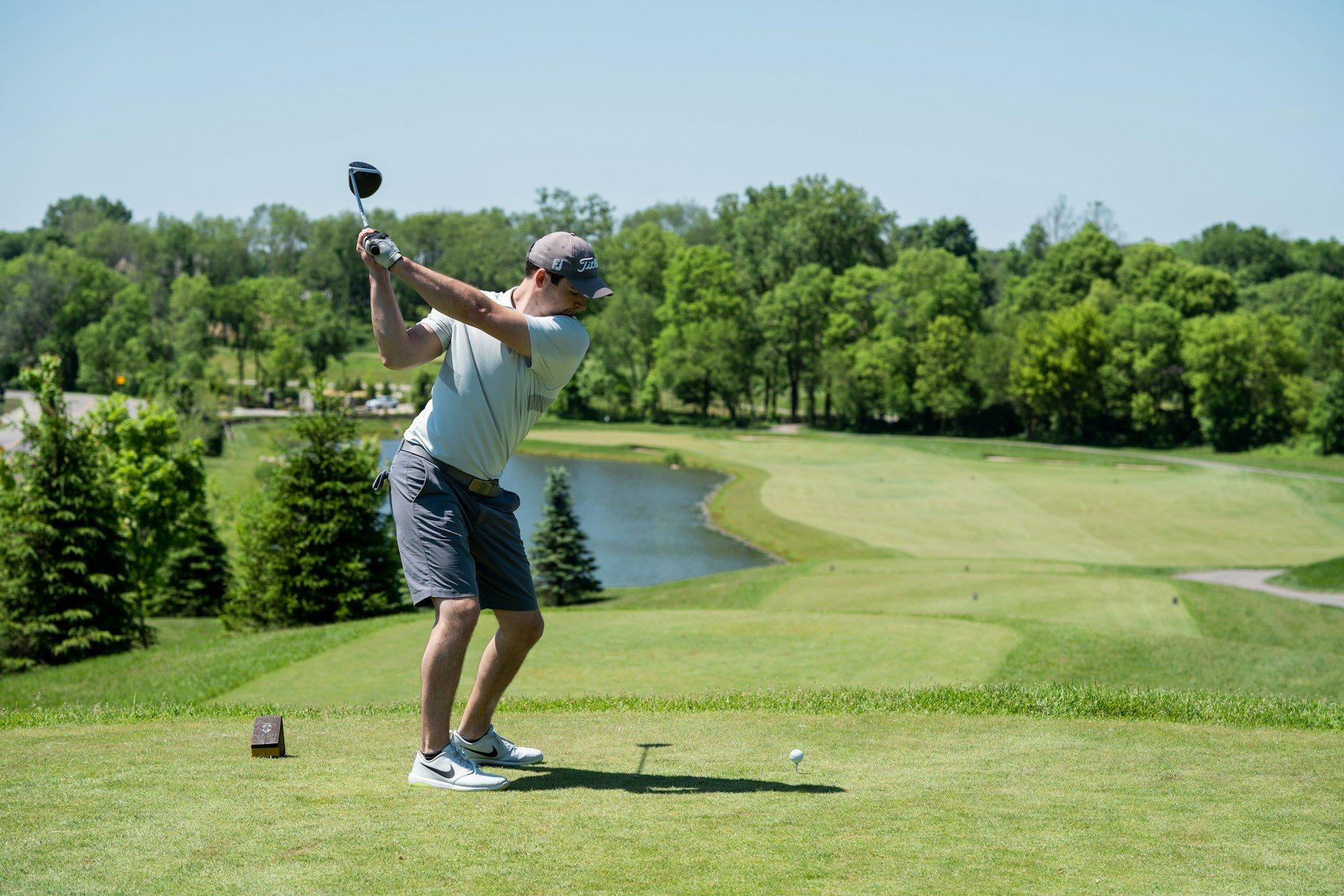A person about to take a swing at golf.