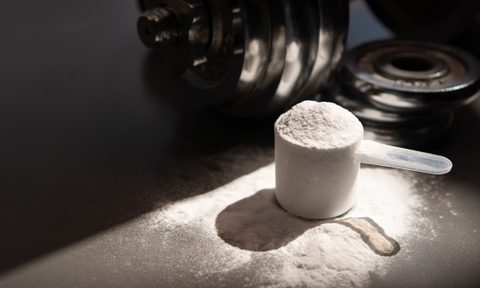 whey protein powder and dumbbell background ,Sports nutrition. Fitness or healthy lifestyle concept.