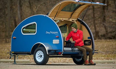 Camper sitting inside the rear hatch of Vistabule's DayTripper teardrop camper.