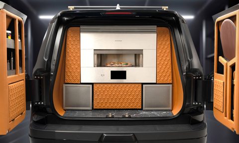 2024 Lexus Monogram GX concept vehicle rear view with doors open revealing pizza oven and bar.