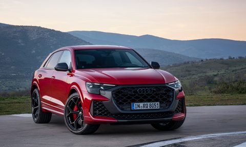 2025 audi q8 rs and performance parked on a helicopter landing pad with mountains in the background