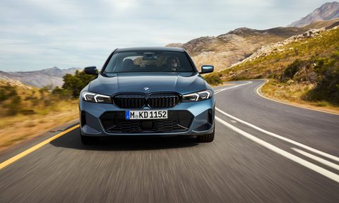 2025 BMW 3 Series direct front view driving on a mountain road.