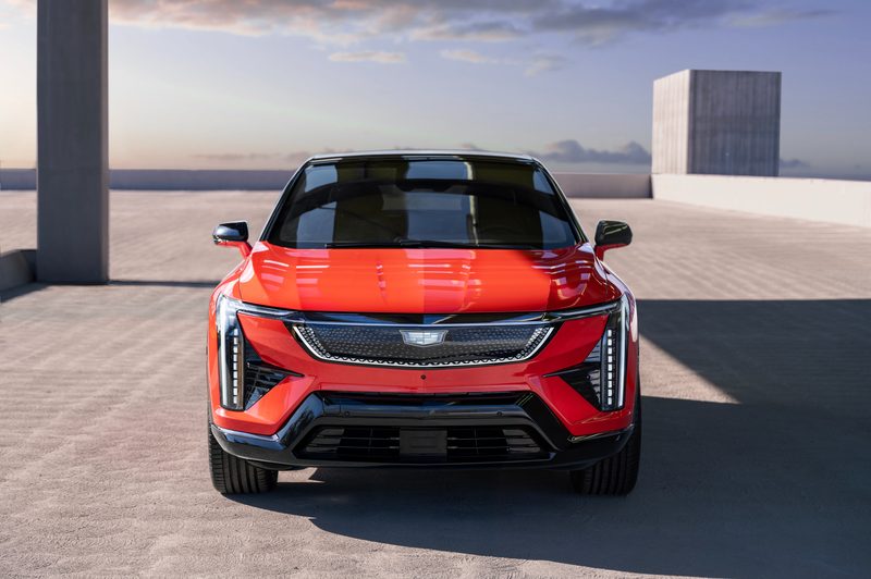 2025 Cadillac Optiq direct front view parked on a concrete rooftop of a contemporary building.