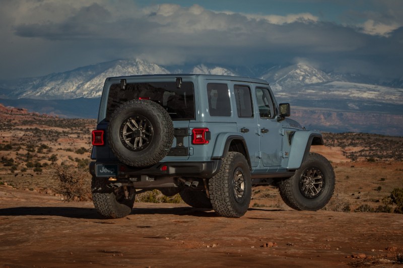 2025 Jeep Wrangler 392 Final Edition rear view parked in the desert with snow covered mountains in the background.