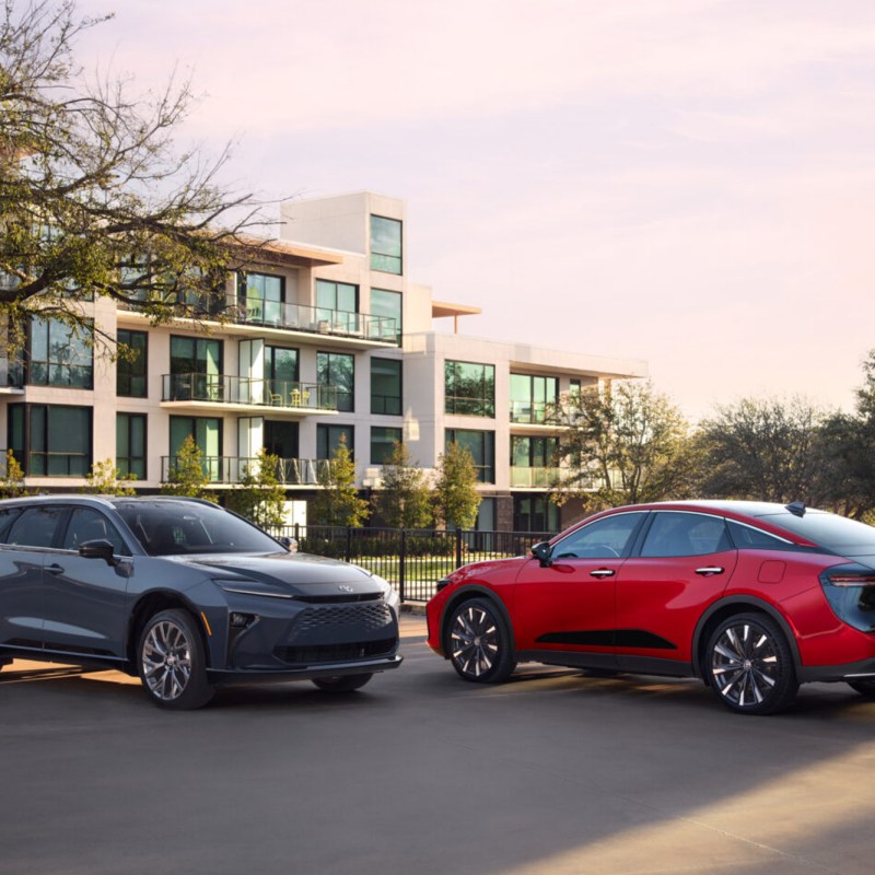 2025 Toyota Crown Signia suv and Crown sedan parked facing each other on a concrete parking area