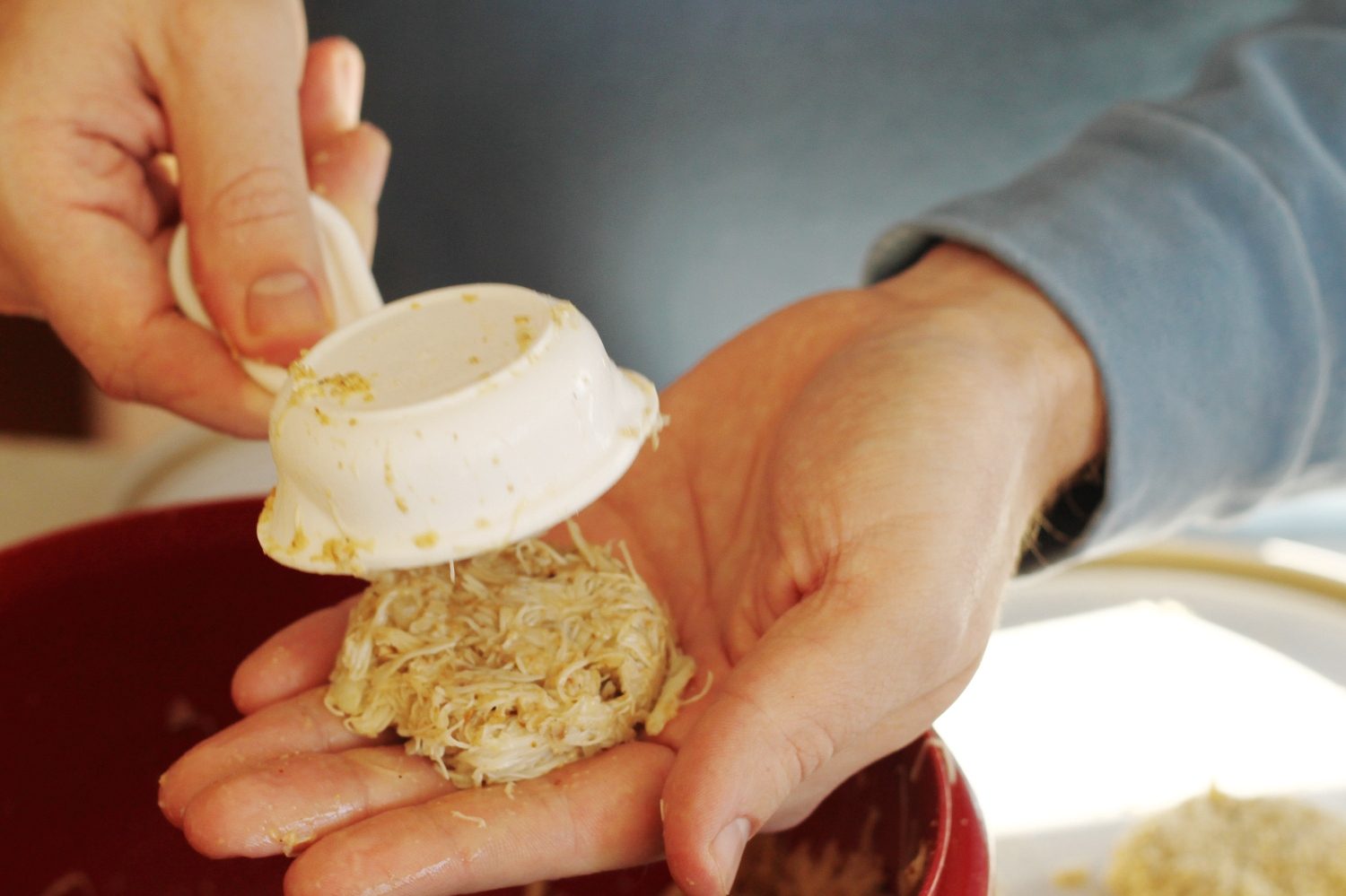Hands shaping crab cake