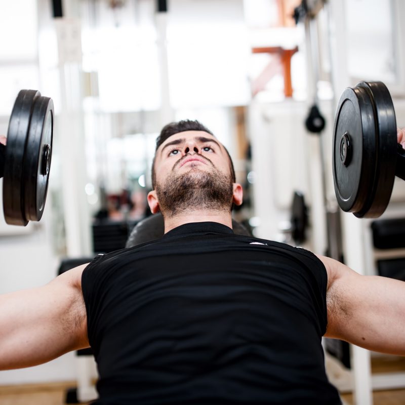 Man doing incline dumbbell press.