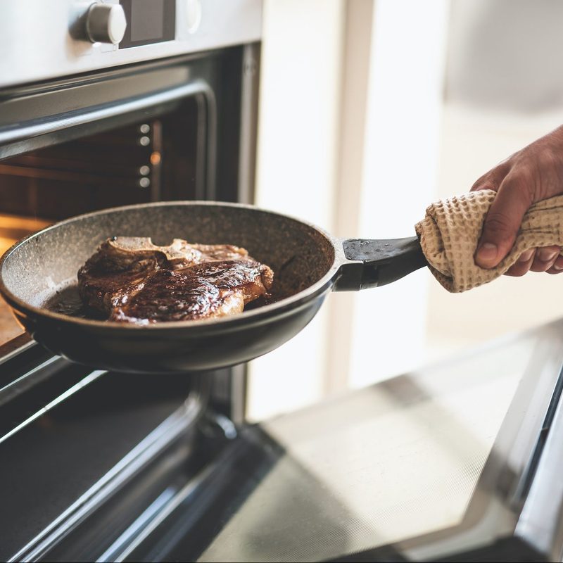 Pan with steak going into oven