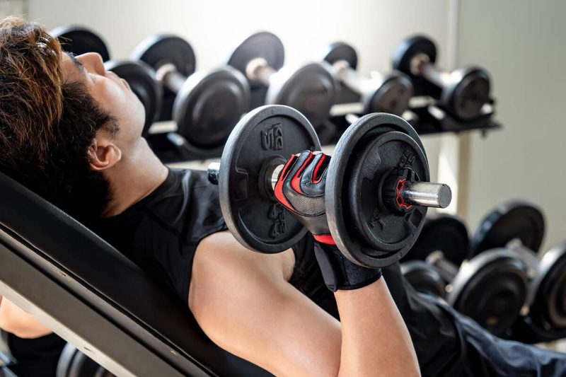 Man doing incline dumbbell press.