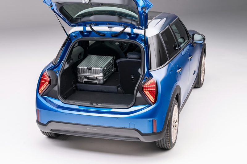 New Mini Cooper S 4-door right rear three-quarter view with hatch open showing rear cargo space.