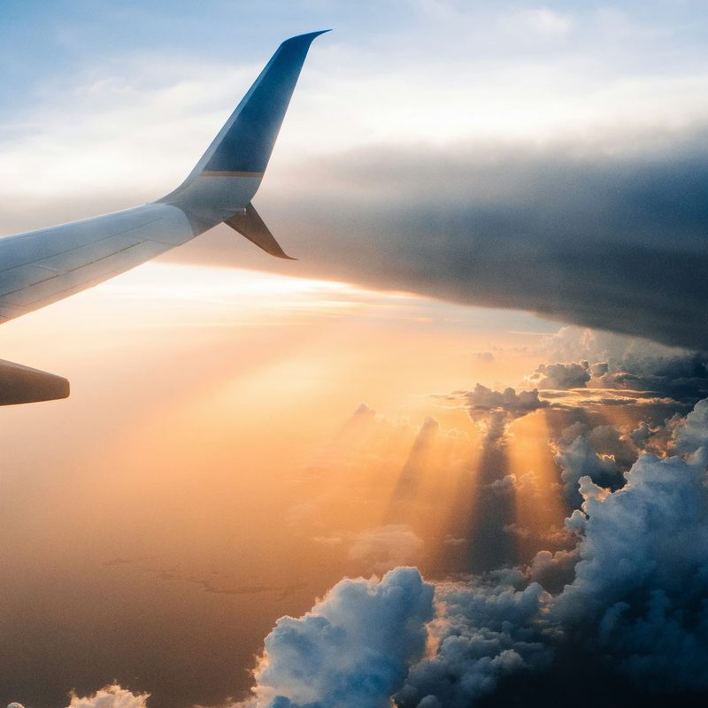 Airplane in sky during sunset