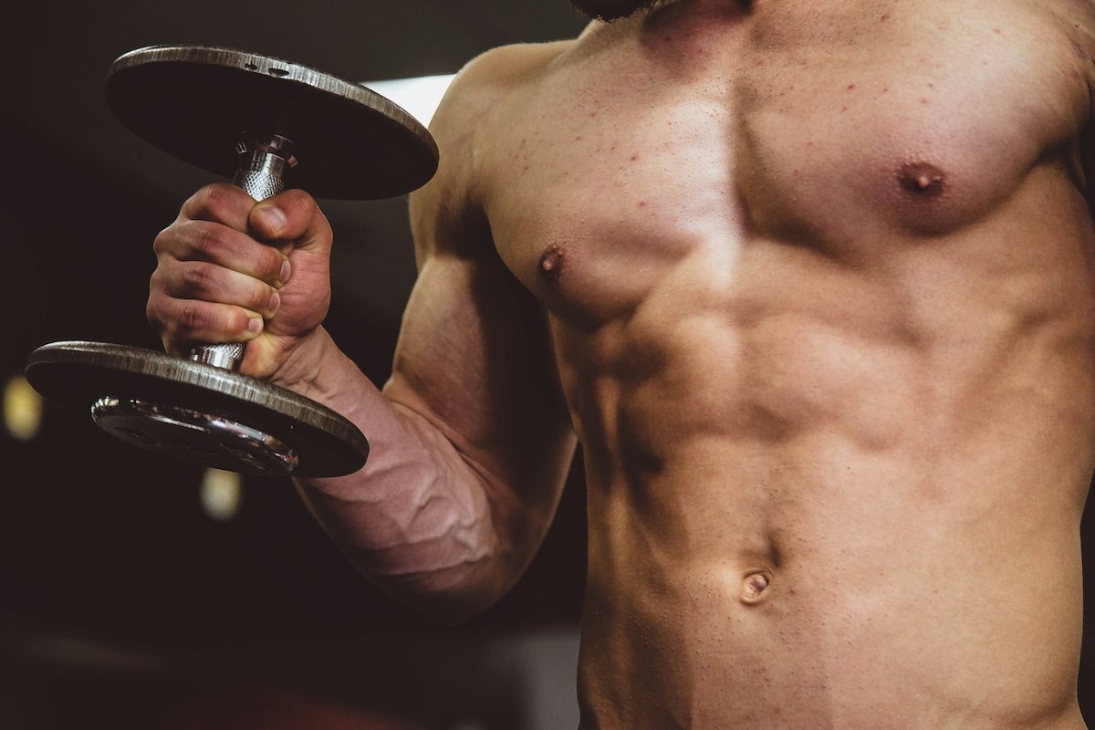 man doing a curl without a shirt on