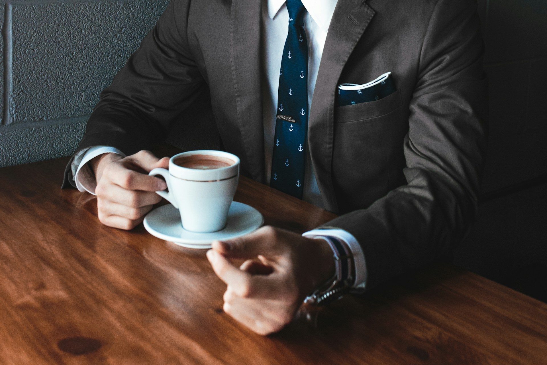Man sitting at table drinking coffee