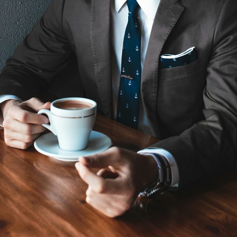 Man sitting at table drinking coffee