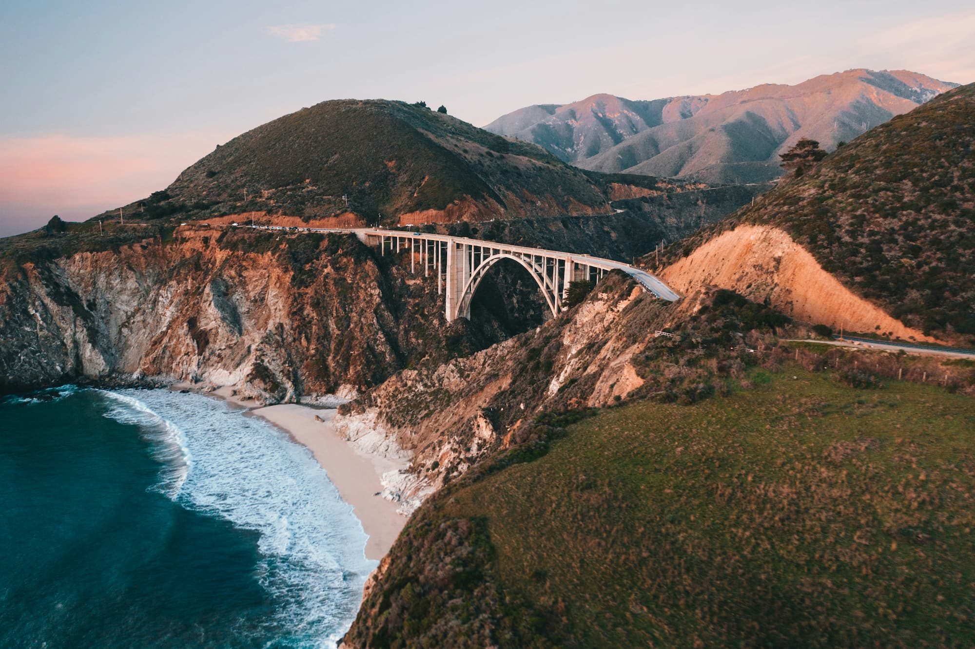 white bridge over sea during daytime