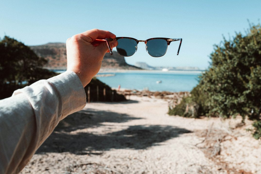 person holding up Clubmaster sunglasses