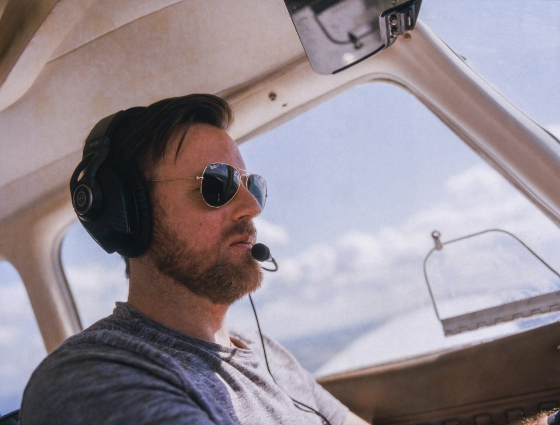 man wearing aviator sunglasses in a car