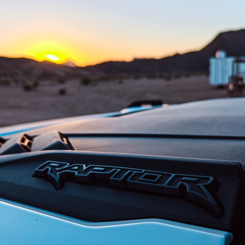 Closeup of the badging on a 2023 Ford Bronco Raptor at sunrise in Terlingua, Texas.
