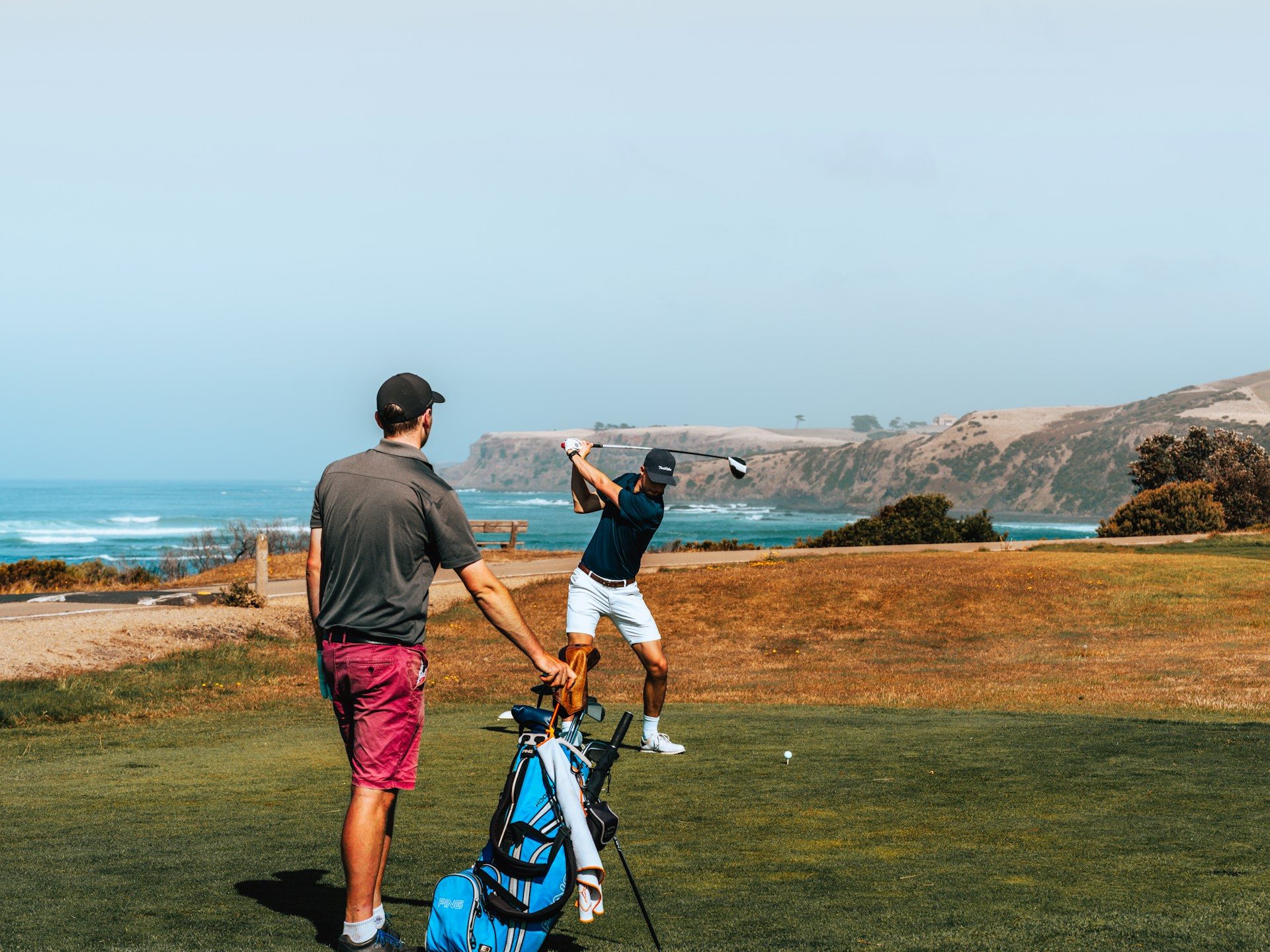Two people playing golf together.