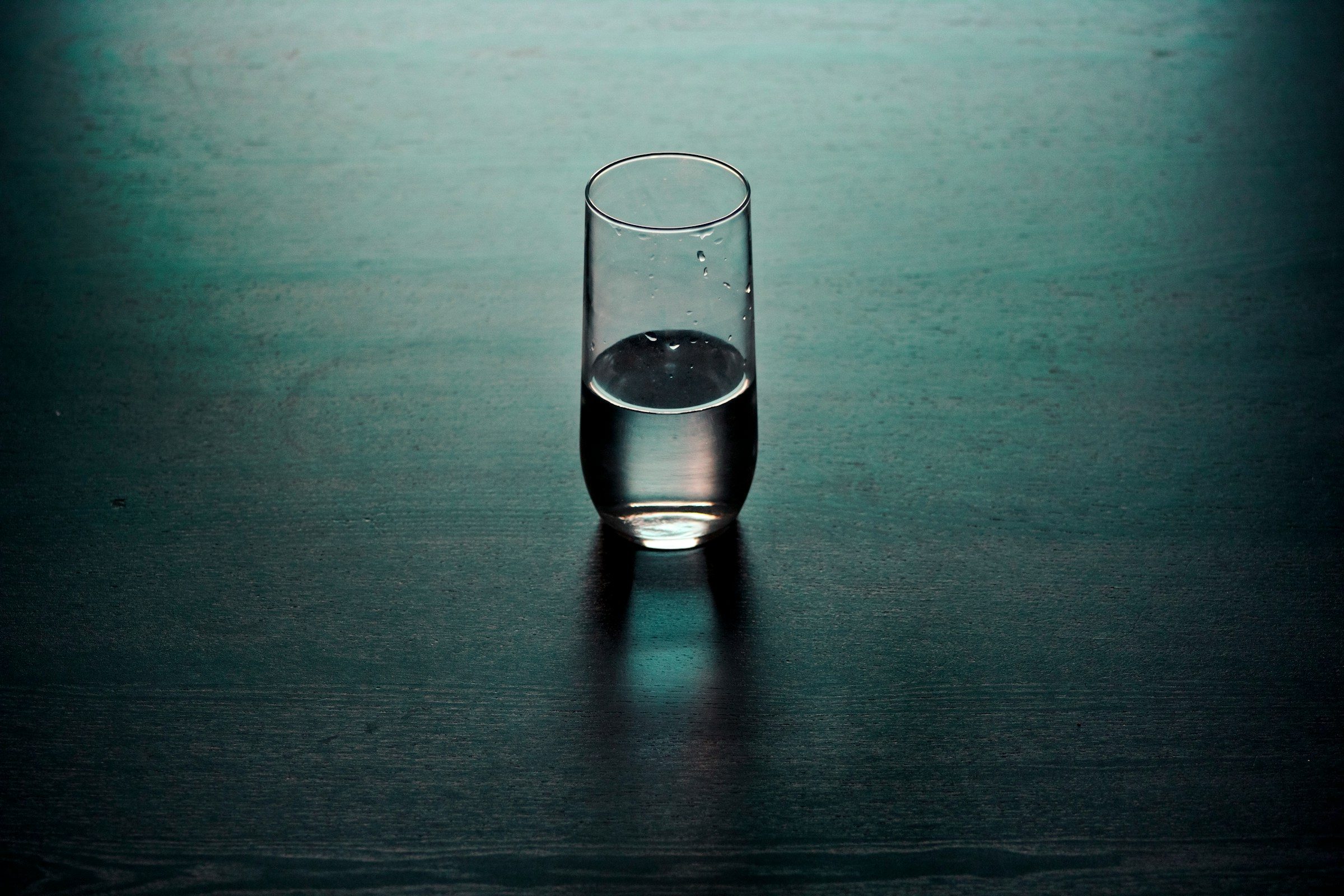 water in glass on blue table