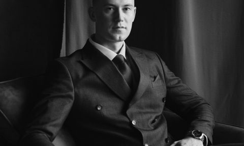 man in double breasted suit sitting