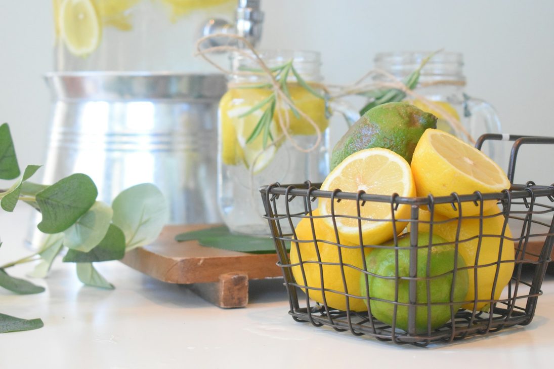 lemon water in pitcher and lemons in tray