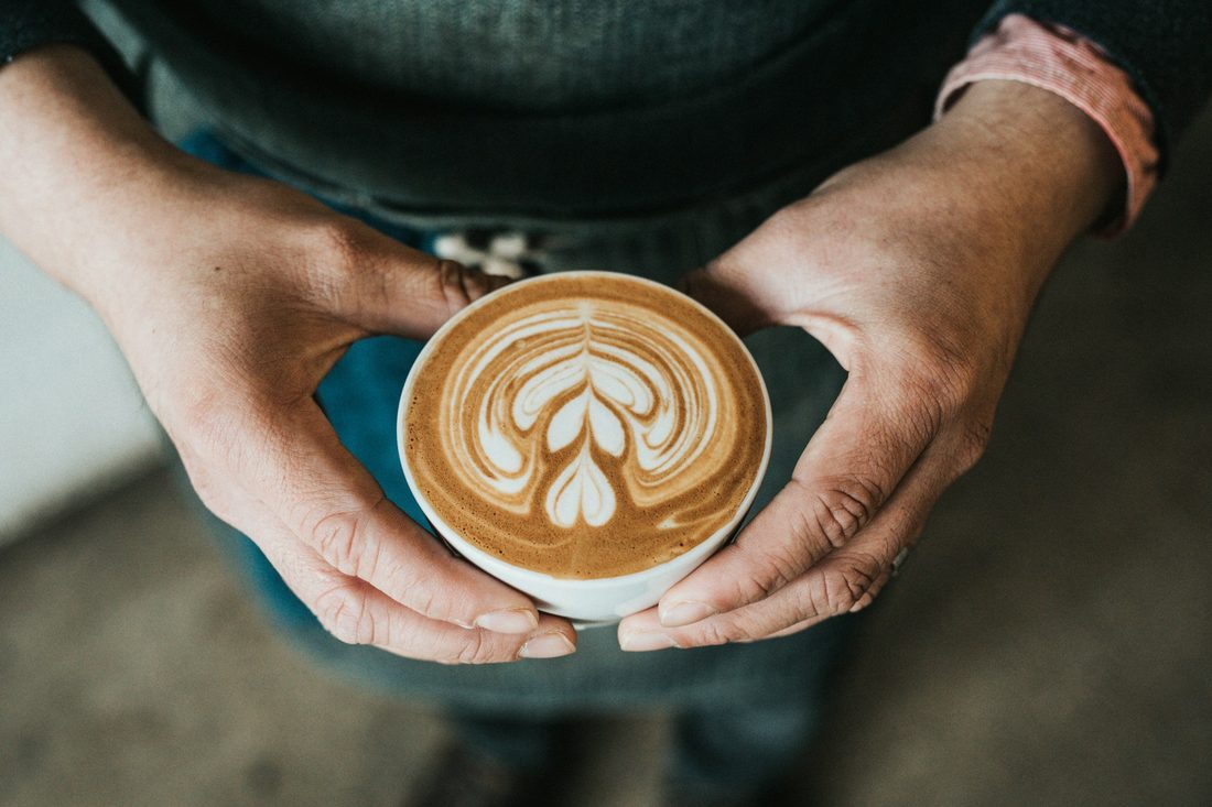 man holding cup of coffee