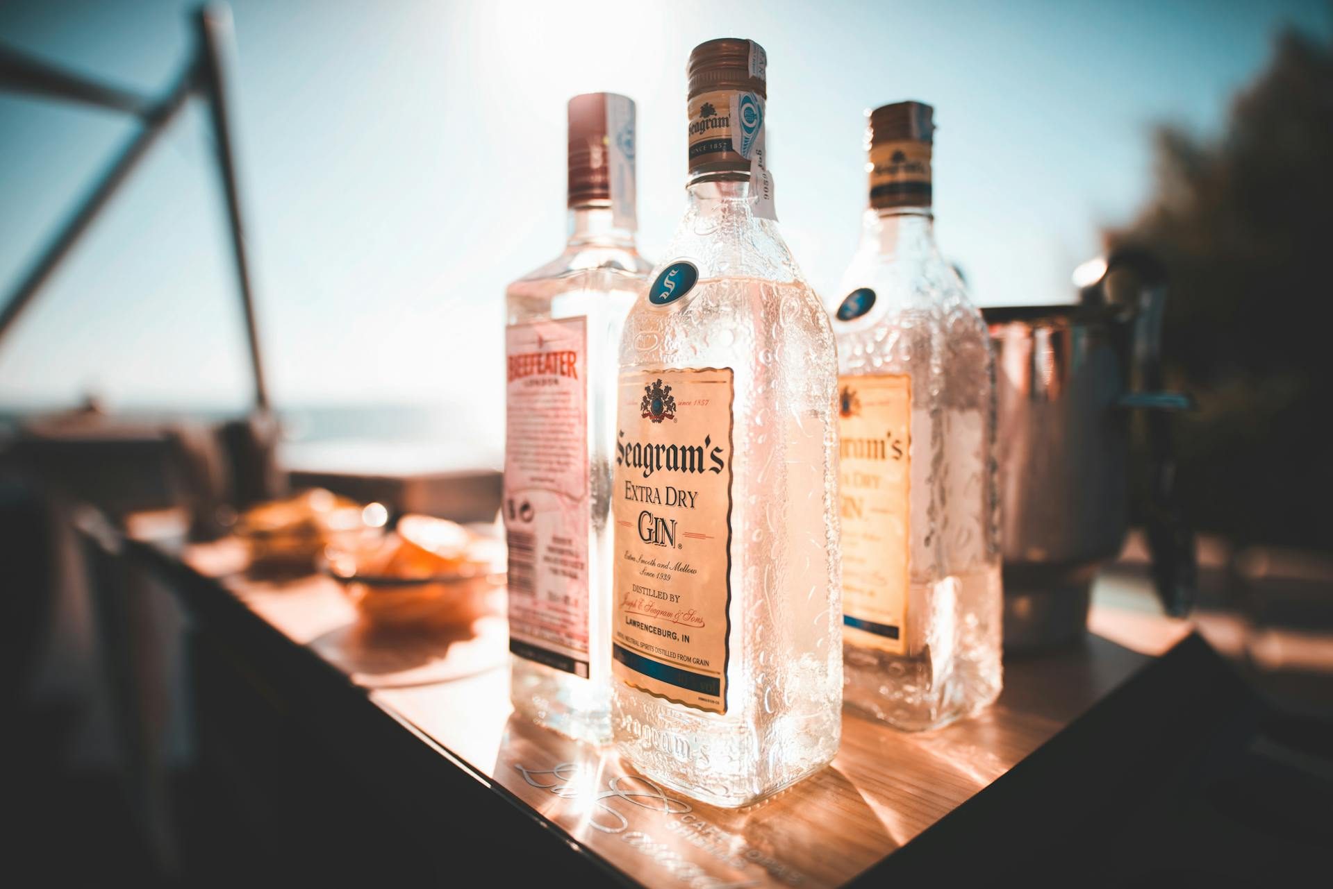 Three different gin bottles sitting on a surface